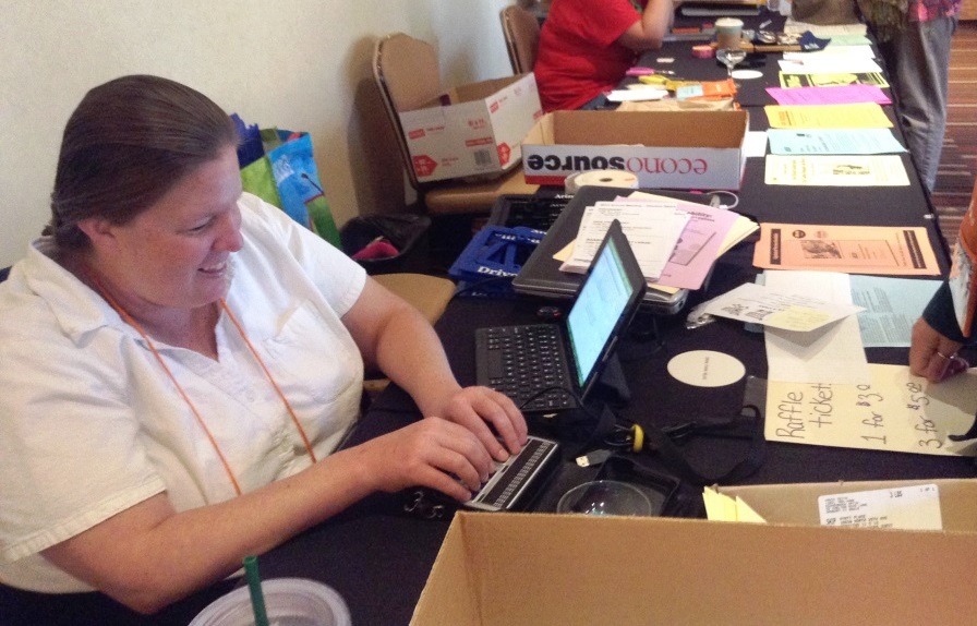 Anna checks in people who have registered at a conference.