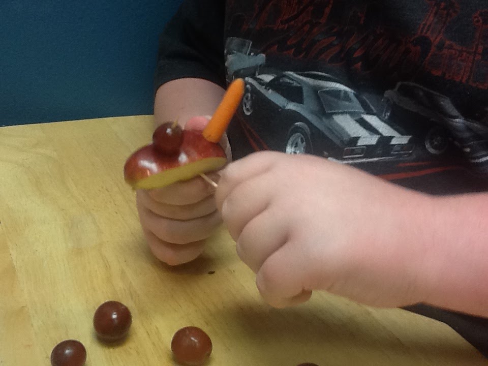 Making an apple car with grape wheels and a carrot Making an apple car with grape wheels
