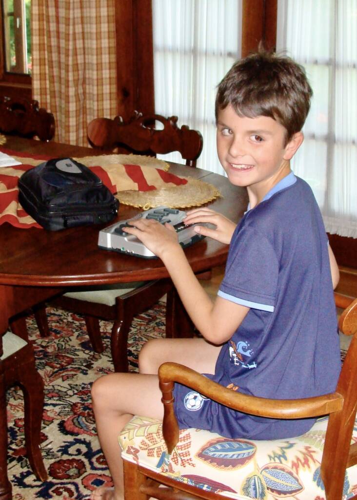 Austin typing on his braille note.