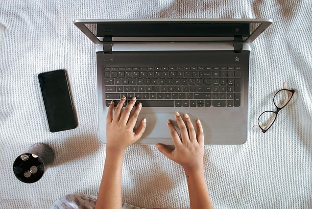 Student typing on a laptop.