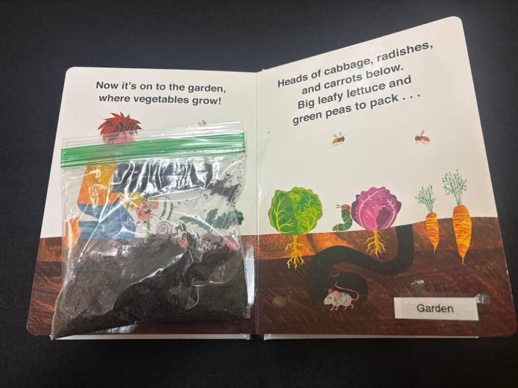 A page in the book that has a zip lock bag added that has garden dirt in it.