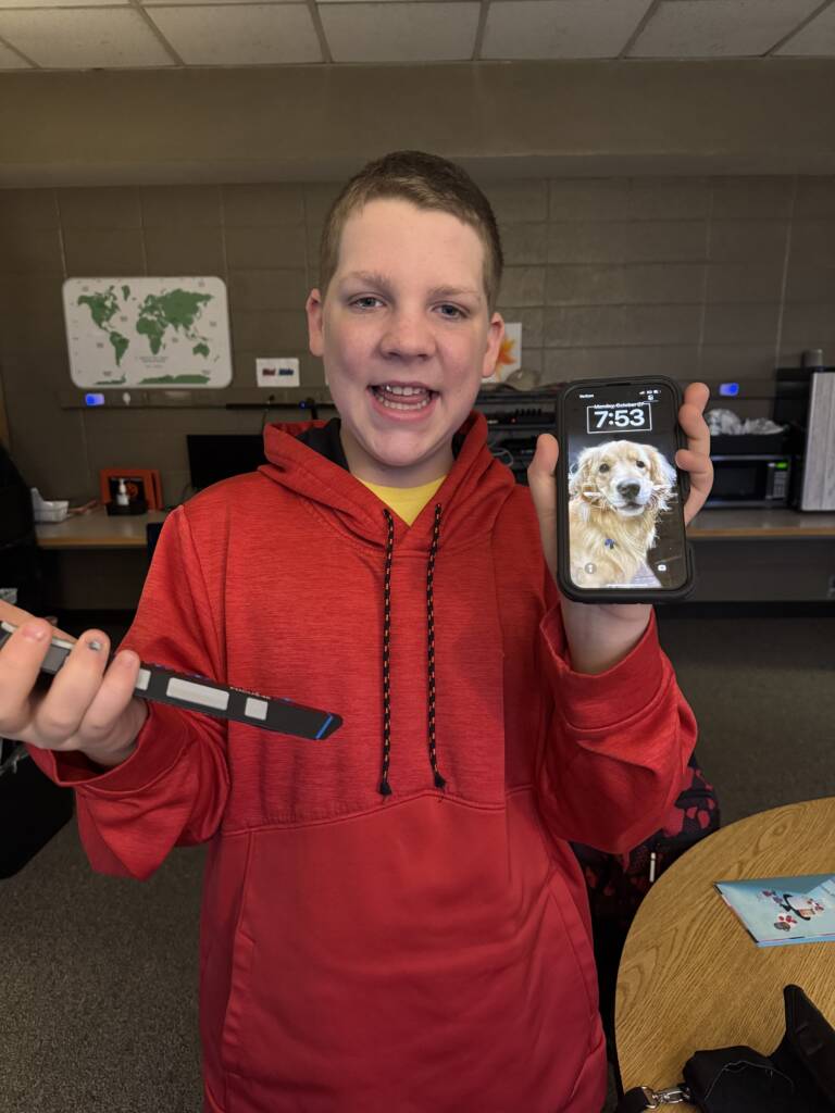 Liam holding up his phone.