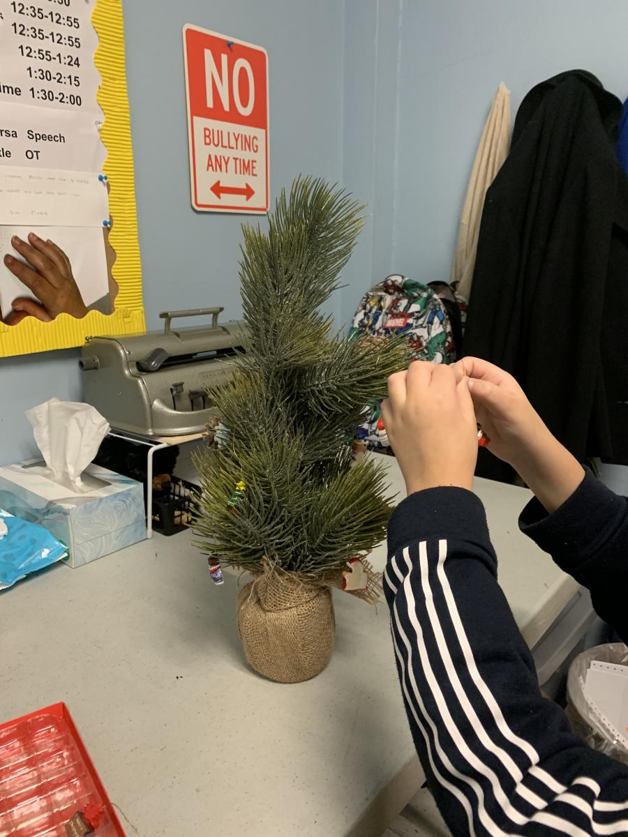 Putting the finishing touches on the tree Putting the finishing touches on the tree