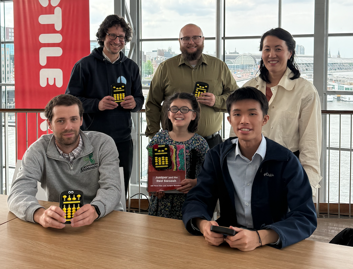 Juniper and the Red Swoosh a group of six team members holding the abacus: Back row from left: Ian Matty, Quentin Roa, and Chi-Hoon Kim. Front row from left: Samuel Foulkes, Juniper Eisenberg, and Richard He.