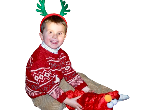 Austin as child with Christmas antlers on his head holding an Elmo.