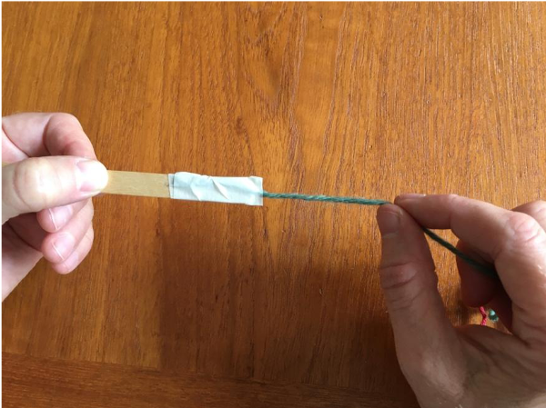 Wrapping masking tape around shed stick Wrapping masking tape around shed stick